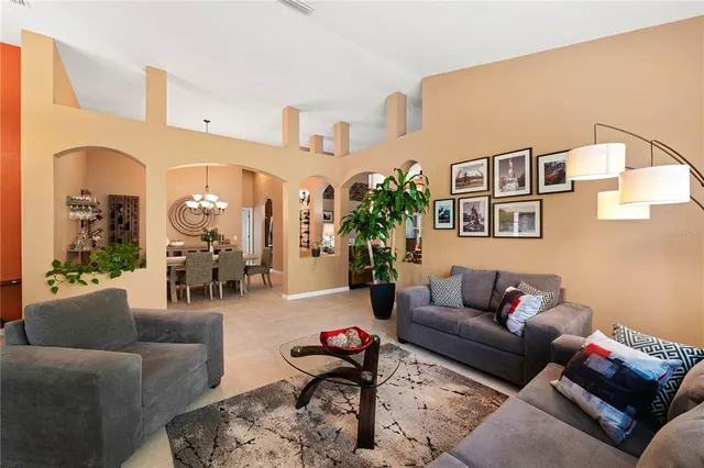 a view of a dining room with furniture and a chandelier