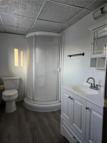a bathroom with a sink a toilet and mirror