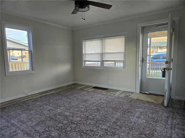 an empty room with windows and closet