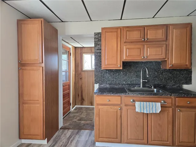 a kitchen with stainless steel appliances granite countertop a refrigerator and a sink