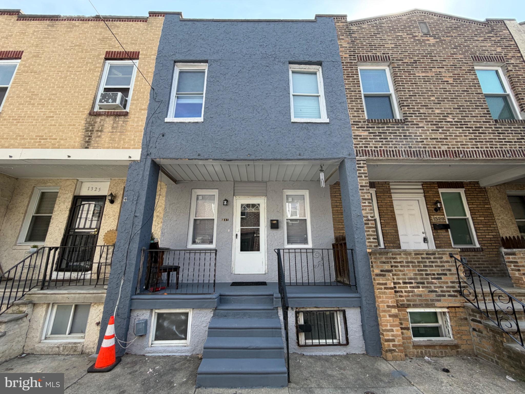 1327 South Newkirk Street Philadelphia, PA 19146 - Photo 2 of 7 front view of a brick house with large windows