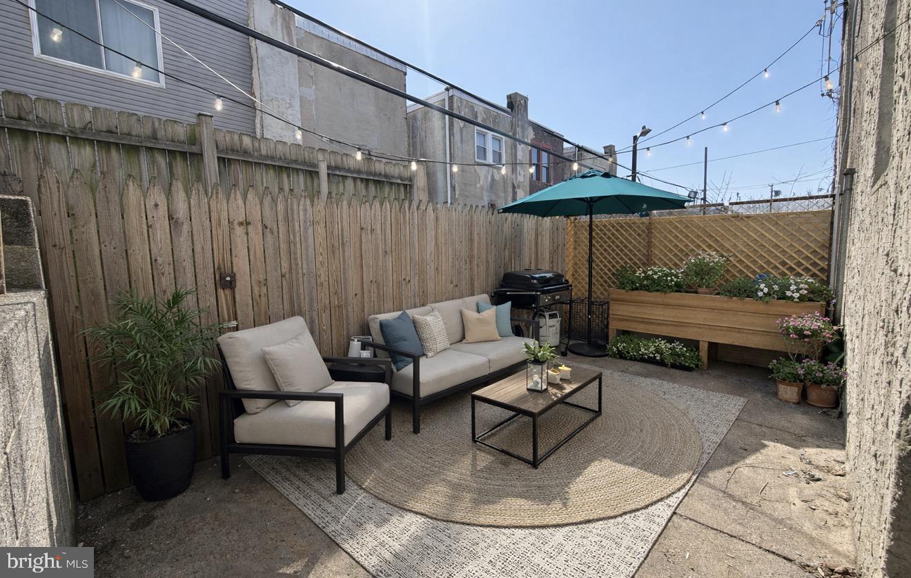 1327 South Newkirk Street Philadelphia, PA 19146 - Photo 7 of 7 a view of a patio with a table and chairs under an umbrella