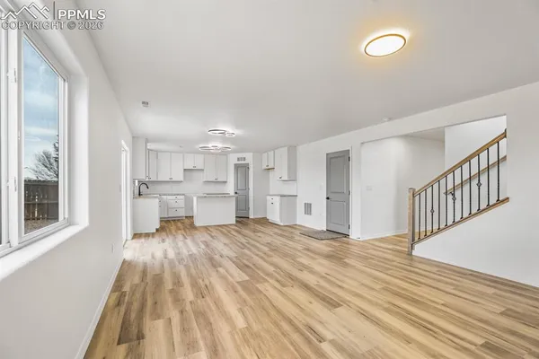 a kitchen with a stove a sink and cabinets