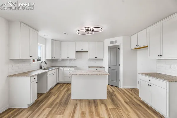 a kitchen with a stove and a refrigerator