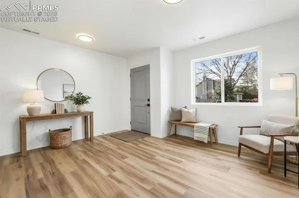 a view of a big room with wooden floor and a bathroom