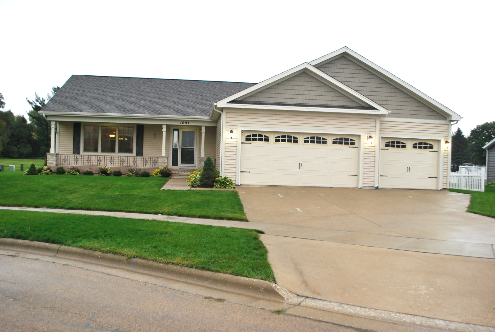 a view of a house with a yard and plants