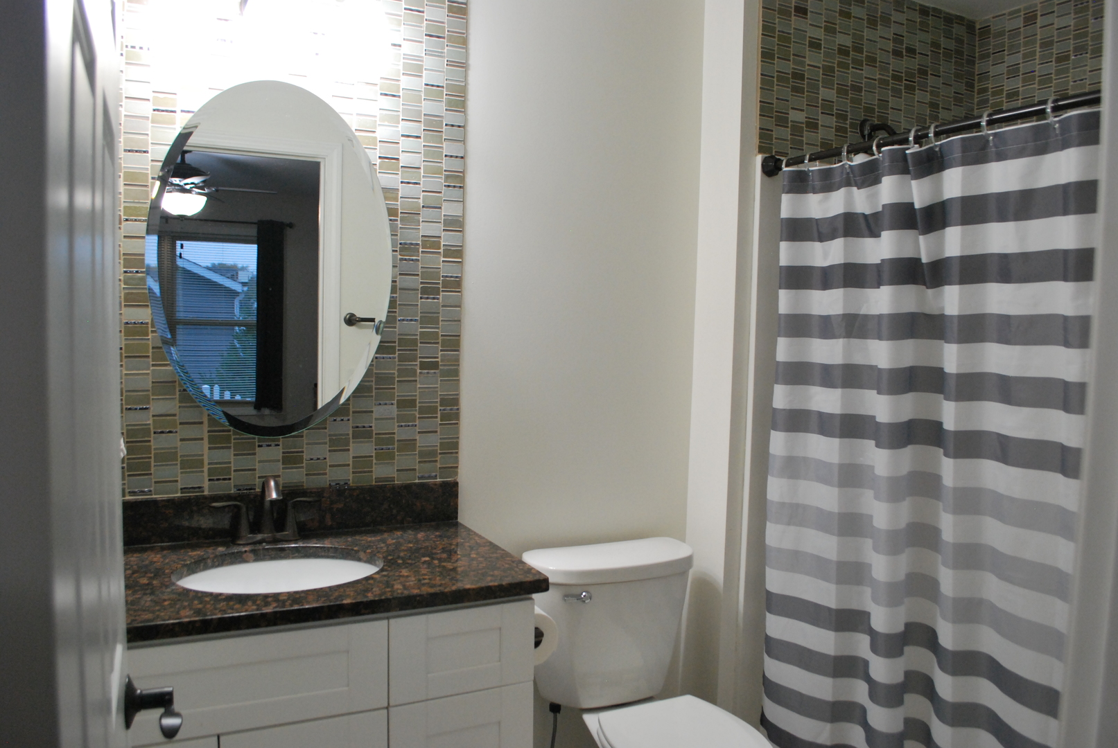1091 Page Way Rochelle, IL 61068 - Photo 13 of 25 a bathroom with a granite countertop sink toilet a mirror and shower