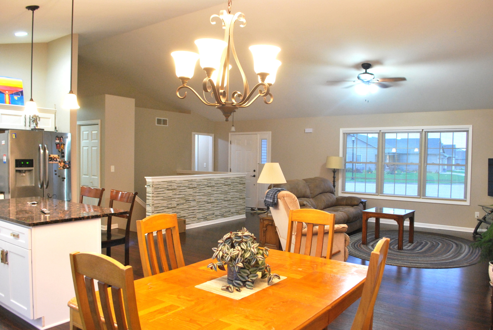 1091 Page Way Rochelle, IL 61068 - Photo 5 of 25 a view of a dining room with furniture a chandelier and large windows