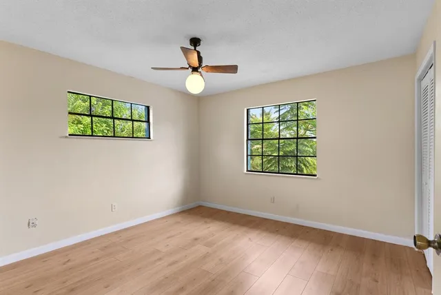 wooden floor in an empty room with a window