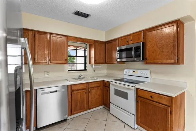 a kitchen with a sink stove and microwave
