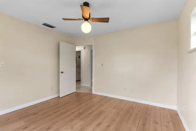 a view of an empty room and wooden floor