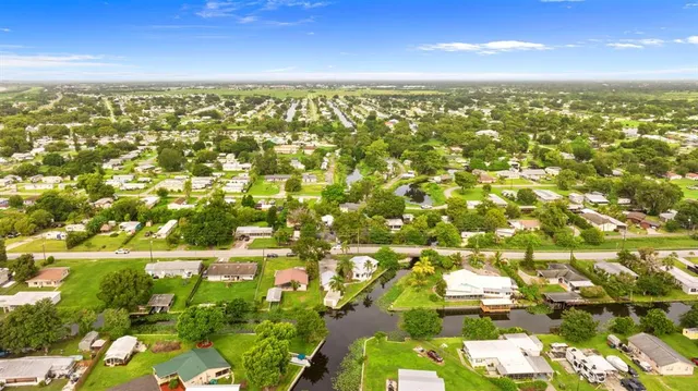 front view of a house with a yard and lake view