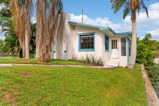 a front view of house with yard and trees
