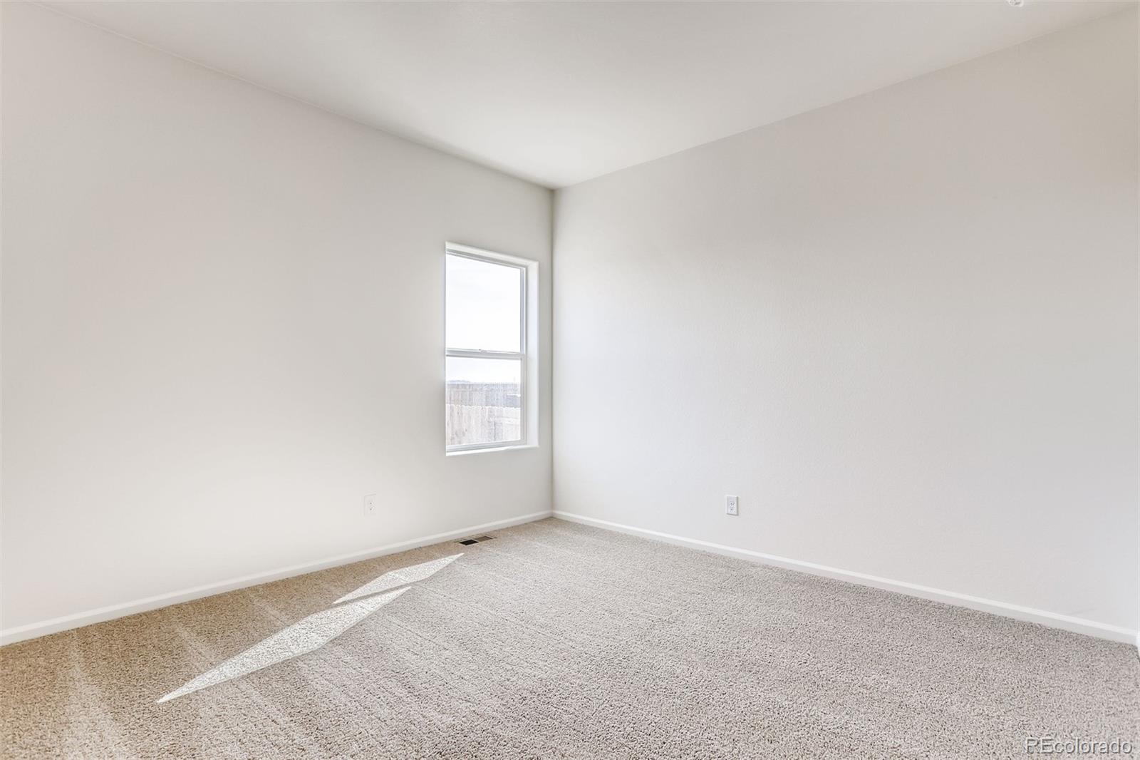 47517 Clover Avenue Bennett, CO 80102 - Photo 12 of 22 an empty room with a window