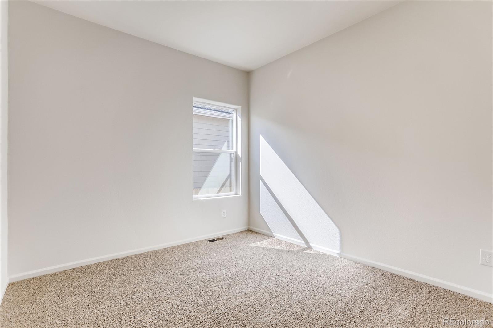 47517 Clover Avenue Bennett, CO 80102 - Photo 16 of 22 an empty room with windows