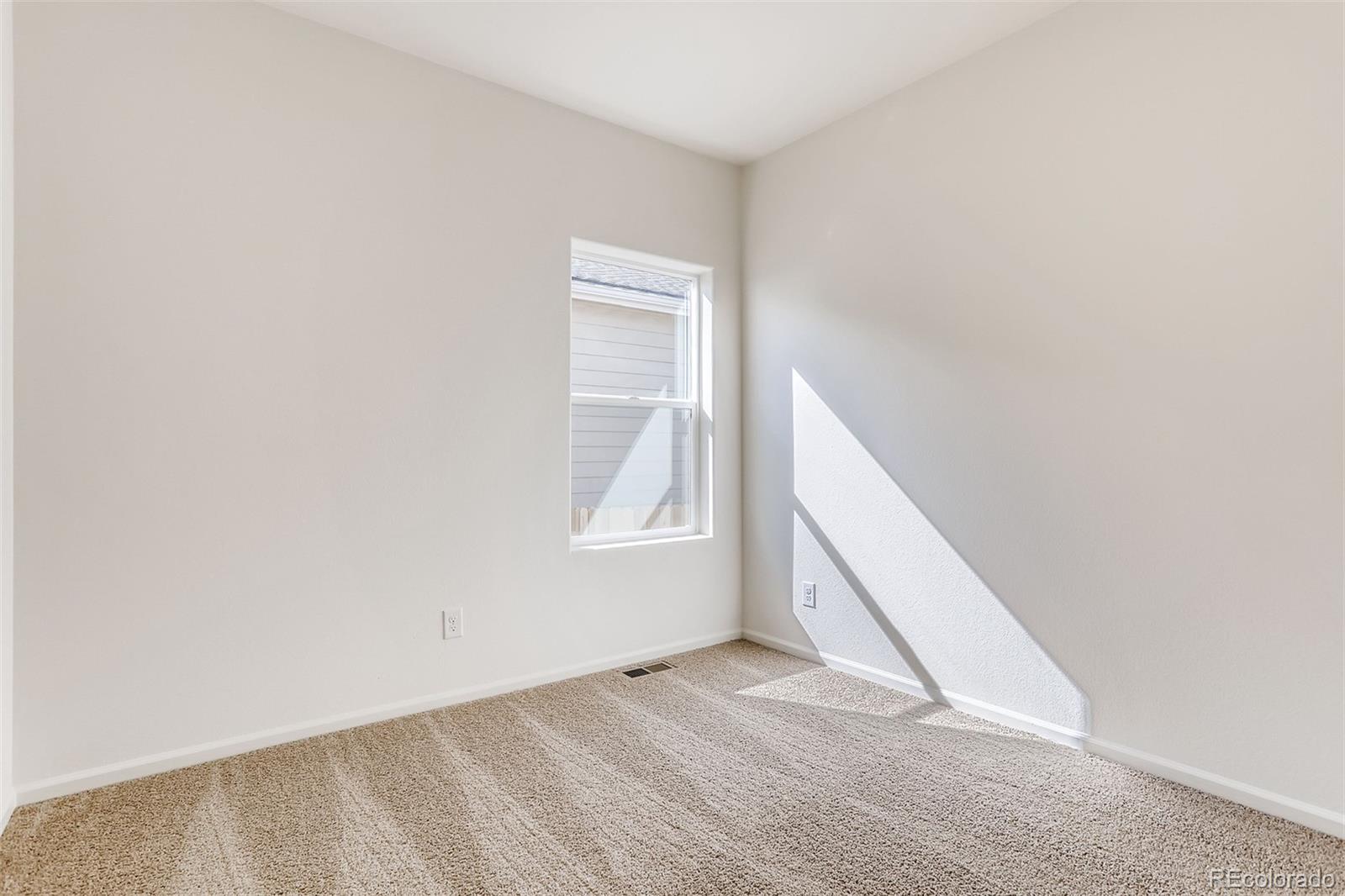 47517 Clover Avenue Bennett, CO 80102 - Photo 20 of 22 an empty room with windows