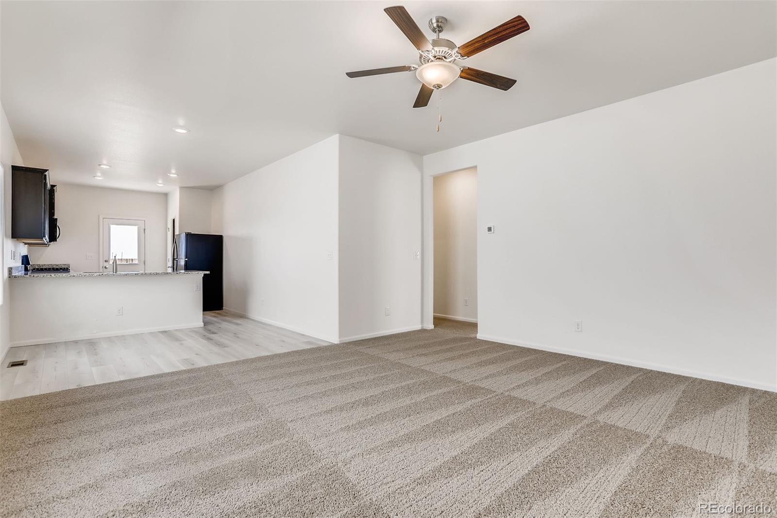 47517 Clover Avenue Bennett, CO 80102 - Photo 3 of 22 a view of a livingroom with a ceiling fan