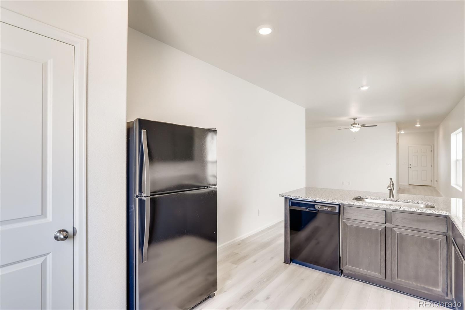 47517 Clover Avenue Bennett, CO 80102 - Photo 10 of 22 a kitchen with a refrigerator and a sink