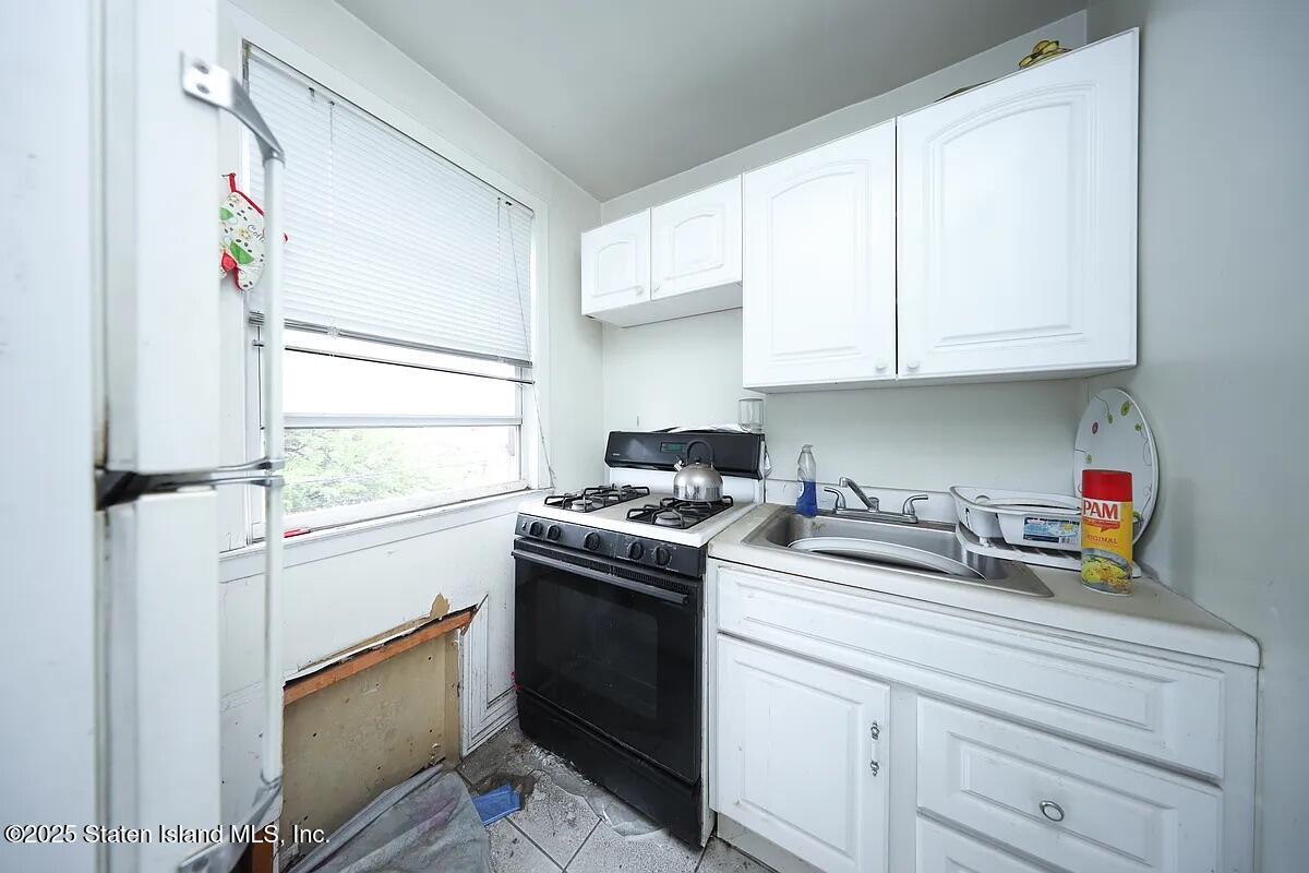 1905 Clove Road Staten Island, NY 10304 - Photo 12 of 29 a kitchen with stainless steel appliances granite countertop a sink and a stove