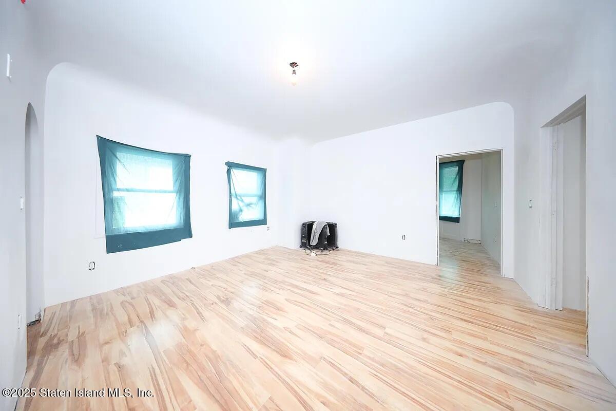 1905 Clove Road Staten Island, NY 10304 - Photo 17 of 29 a view of empty room with wooden floor and fan