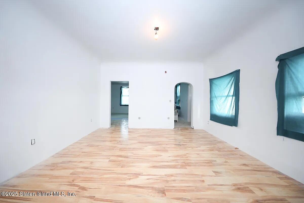 1905 Clove Road Staten Island, NY 10304 - Photo 18 of 29 a large white bed in a white room