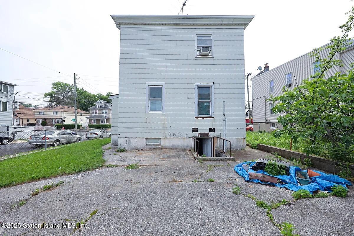 1905 Clove Road Staten Island, NY 10304 - Photo 3 of 29 a brick house with lots of green space and outdoor seating