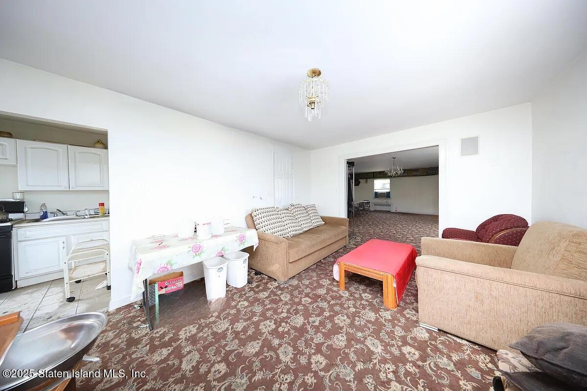 1905 Clove Road Staten Island, NY 10304 - Photo 9 of 29 a living room with furniture and wooden floor