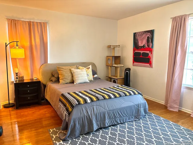 a view of a bedroom with wooden floor and closet