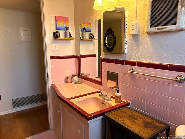 a bathroom with a toilet a sink and mirror