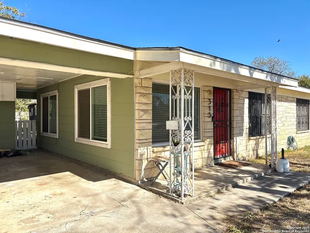 a view of a yard with wooden fence
