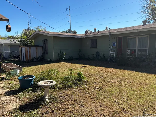 a backyard of a house with barbeque oven and outdoor seating