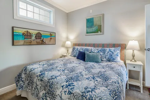 a bedroom with a bed and painting on the wall