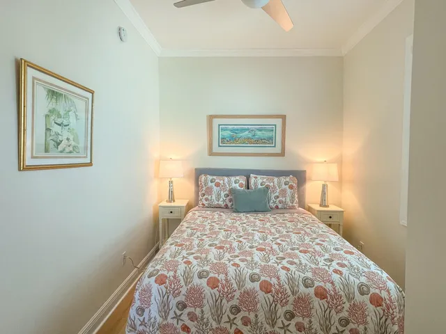 a bedroom with a large bed and a painting on the wall