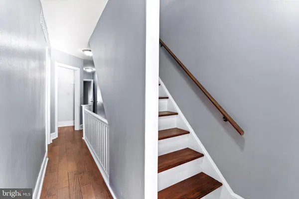 a view of entryway and hall with wooden floor