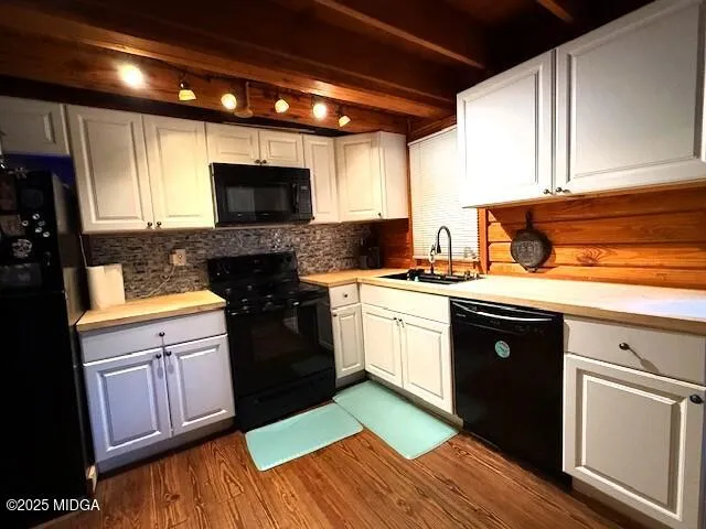 a kitchen with a sink stove and microwave