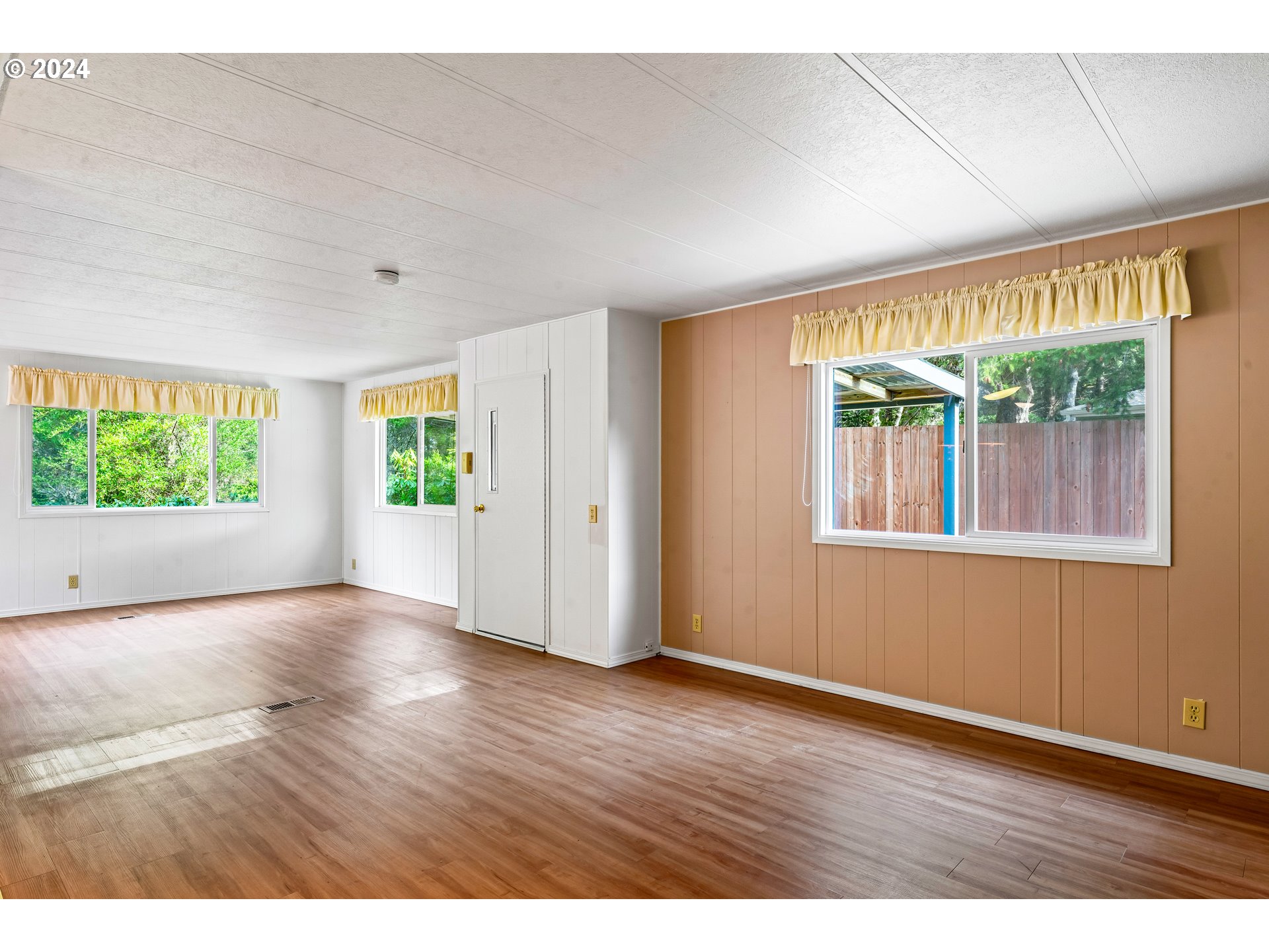 1600 Rhododendron Drive, Unit 406 Florence, OR 97439 - Photo 11 of 42 an empty room with wooden floor and windows
