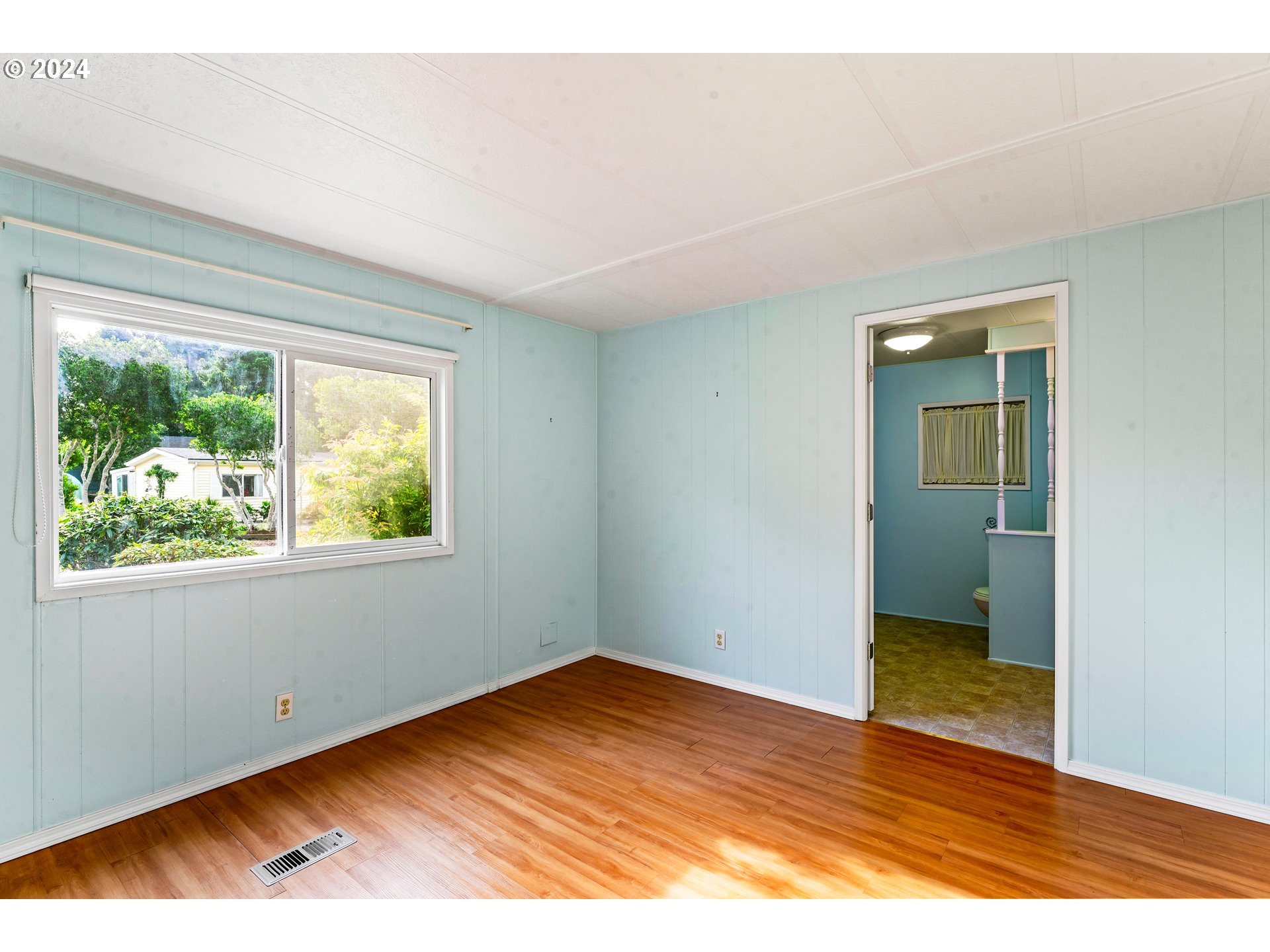 1600 Rhododendron Drive, Unit 406 Florence, OR 97439 - Photo 20 of 42 an empty room with wooden floor and windows