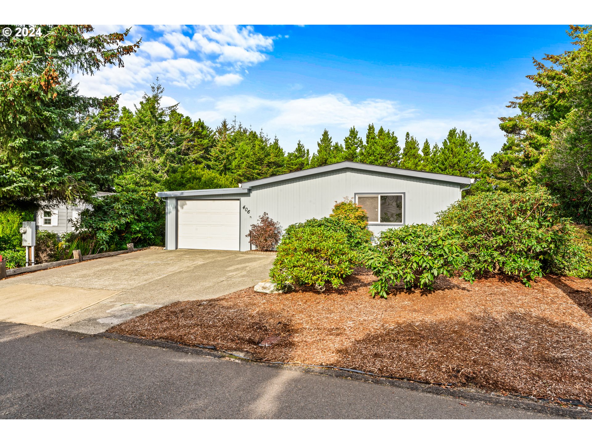 1600 Rhododendron Drive, Unit 406 Florence, OR 97439 - Photo 2 of 42 a view of a yard with potted plants