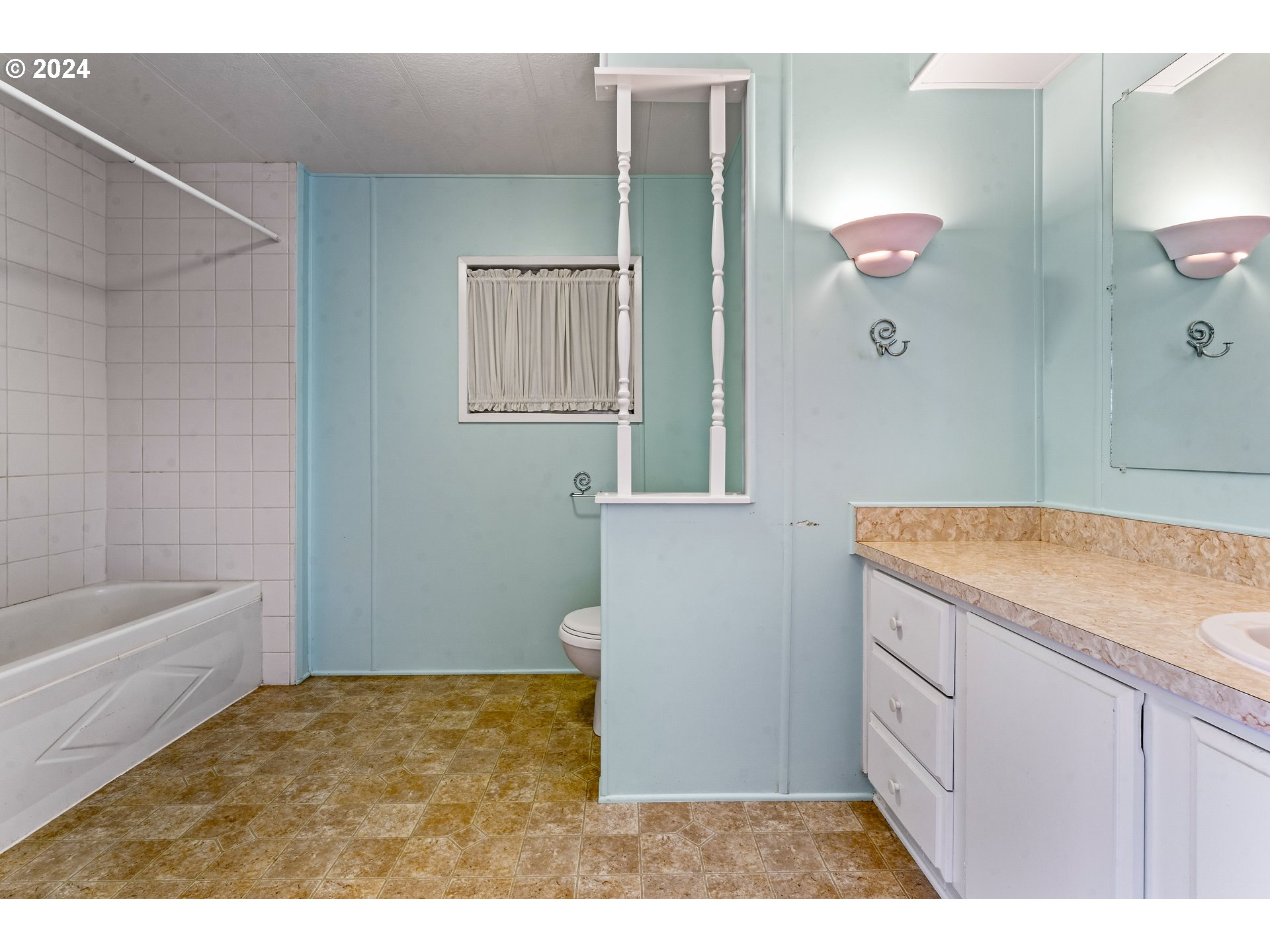 1600 Rhododendron Drive, Unit 406 Florence, OR 97439 - Photo 21 of 42 a bathroom with a granite countertop sink a mirror and a bathtub