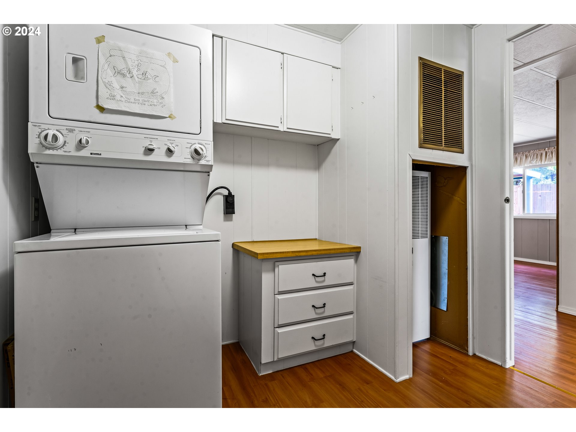 1600 Rhododendron Drive, Unit 406 Florence, OR 97439 - Photo 26 of 42 a kitchen with cabinets and a refrigerator
