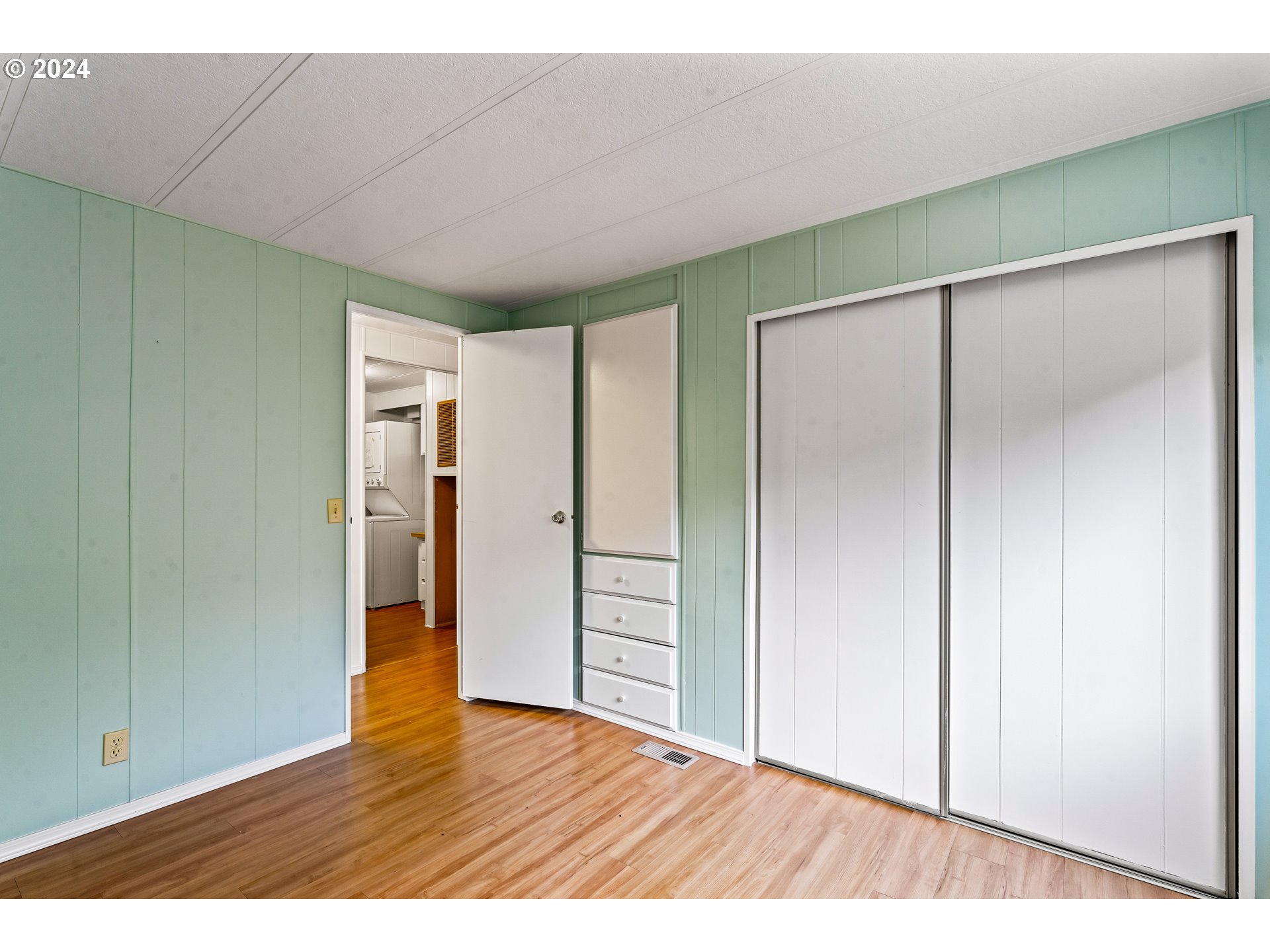 1600 Rhododendron Drive, Unit 406 Florence, OR 97439 - Photo 31 of 42 a view of an empty room with wooden floor and closet