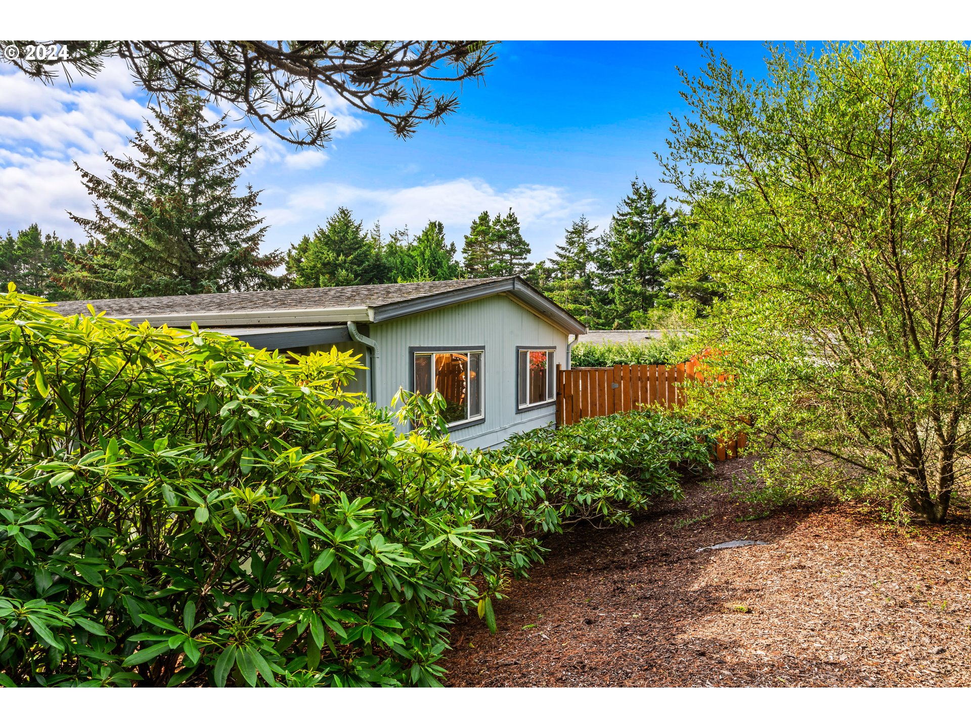 1600 Rhododendron Drive, Unit 406 Florence, OR 97439 - Photo 33 of 42 a view of a backyard with plants