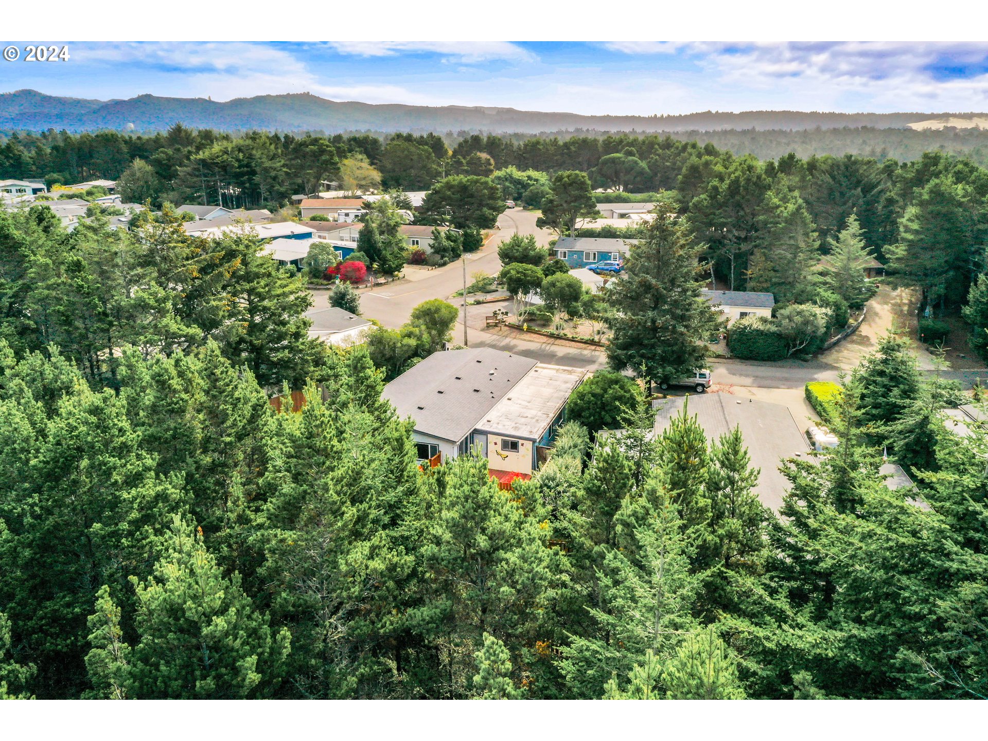 1600 Rhododendron Drive, Unit 406 Florence, OR 97439 - Photo 35 of 42 a view of a city with lush green forest