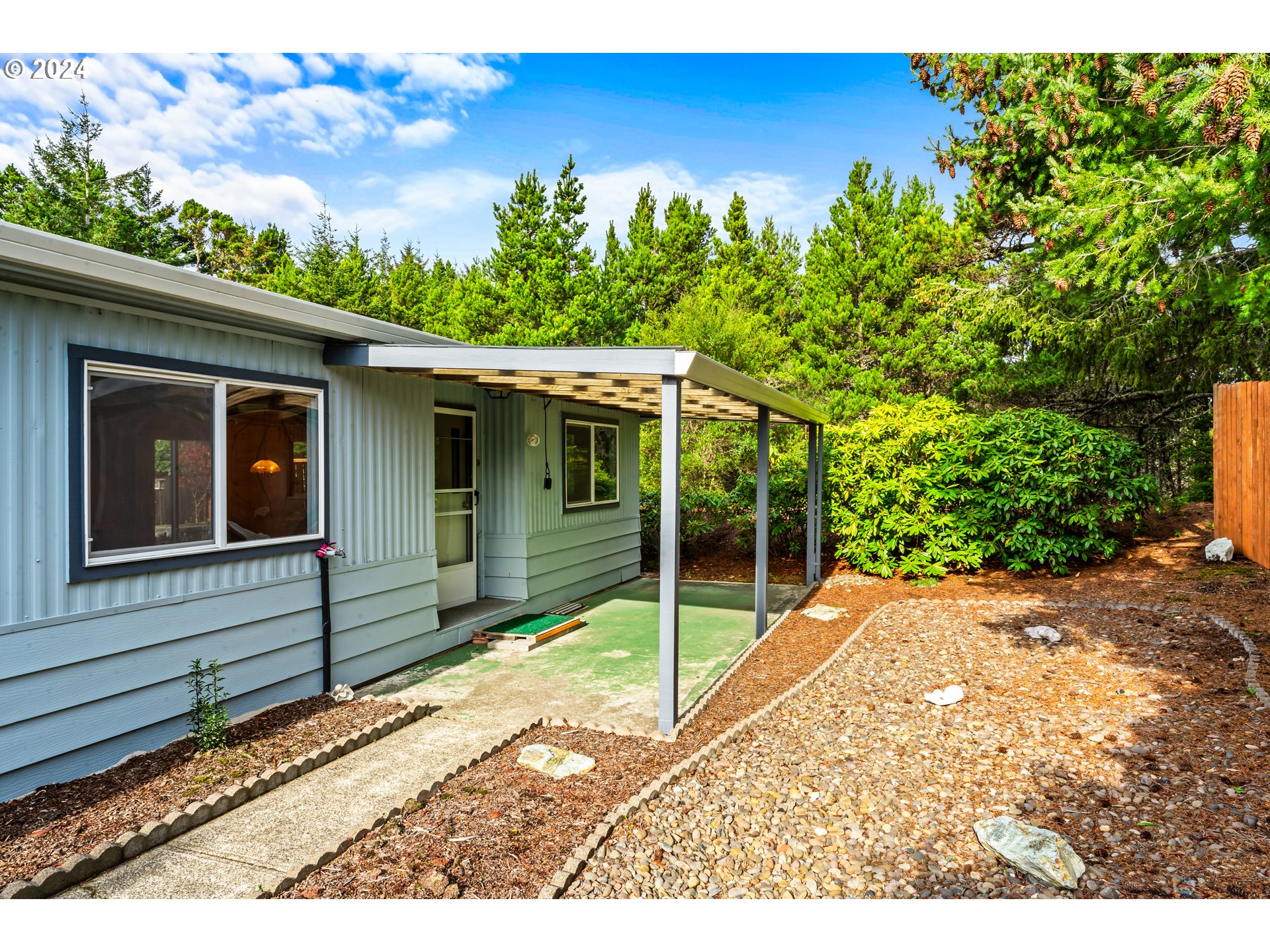 1600 Rhododendron Drive, Unit 406 Florence, OR 97439 - Photo 4 of 42 a house with trees in the background