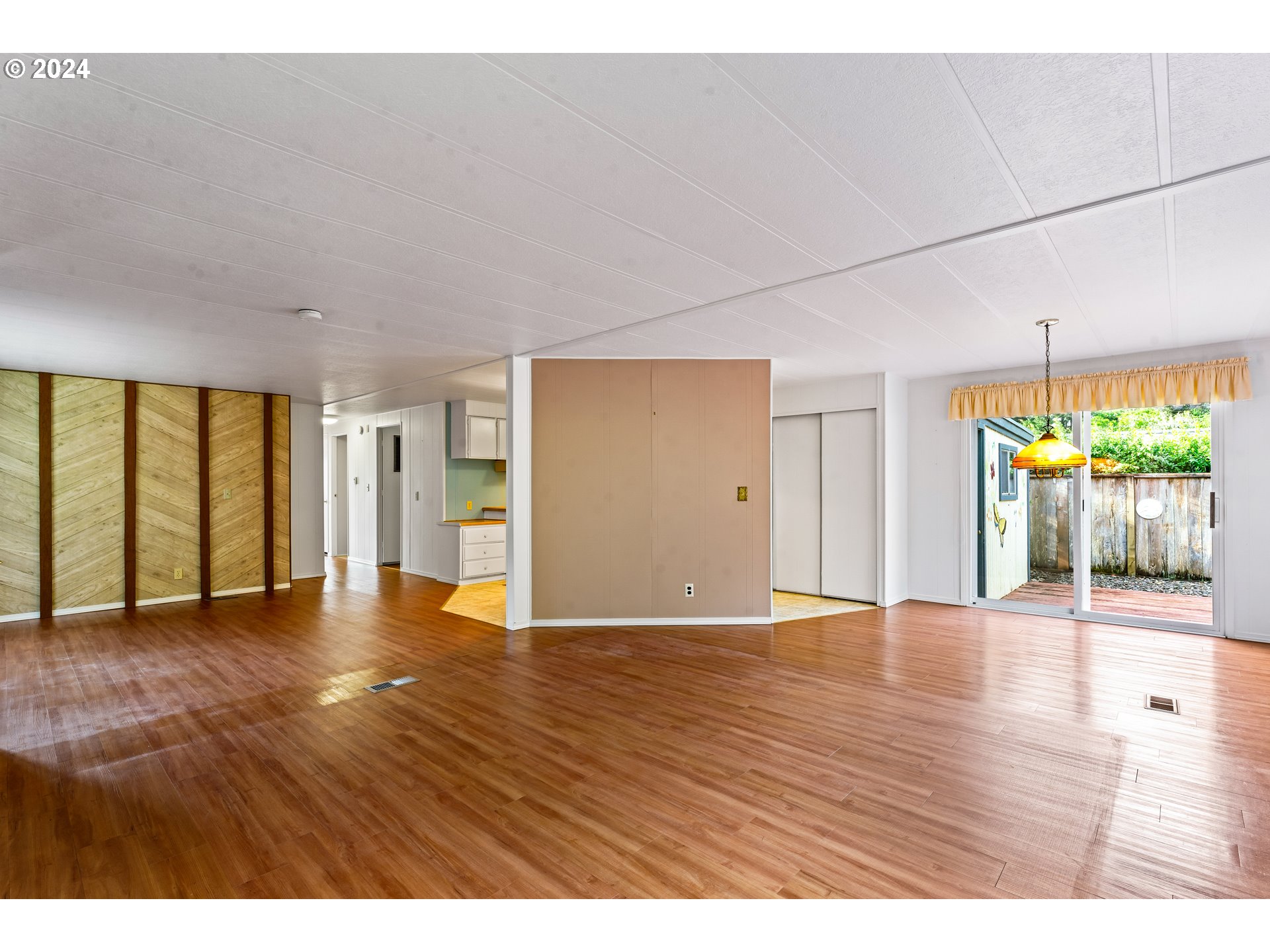 1600 Rhododendron Drive, Unit 406 Florence, OR 97439 - Photo 8 of 42 a view of an empty room with window and wooden floor