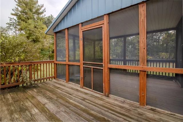 a view of balcony with floor to ceiling window and wooden floor