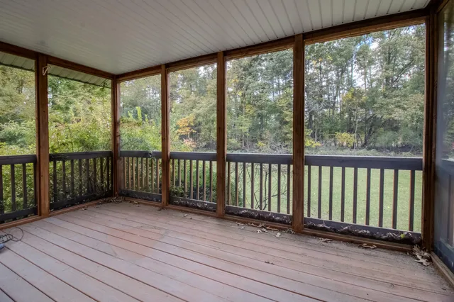 a view of a room with wooden floor and windows