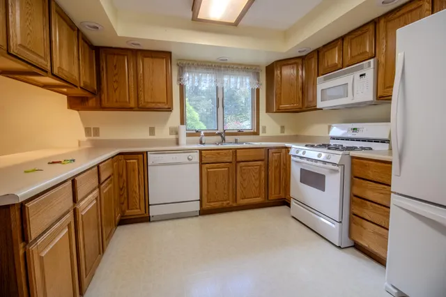 a kitchen with a stove sink and cabinets