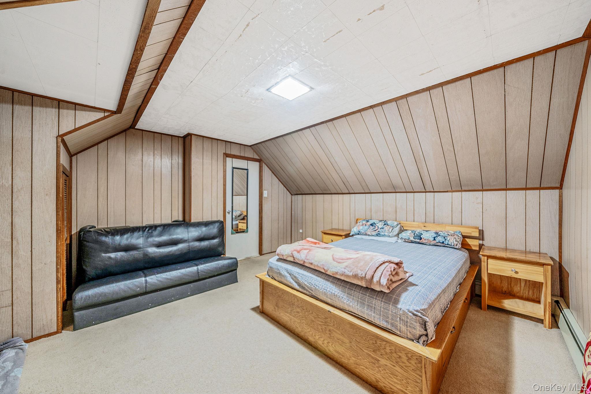 98 Miriam Street Valley Stream, NY 11581 - Photo 13 of 16 a bedroom with a bed and a couch