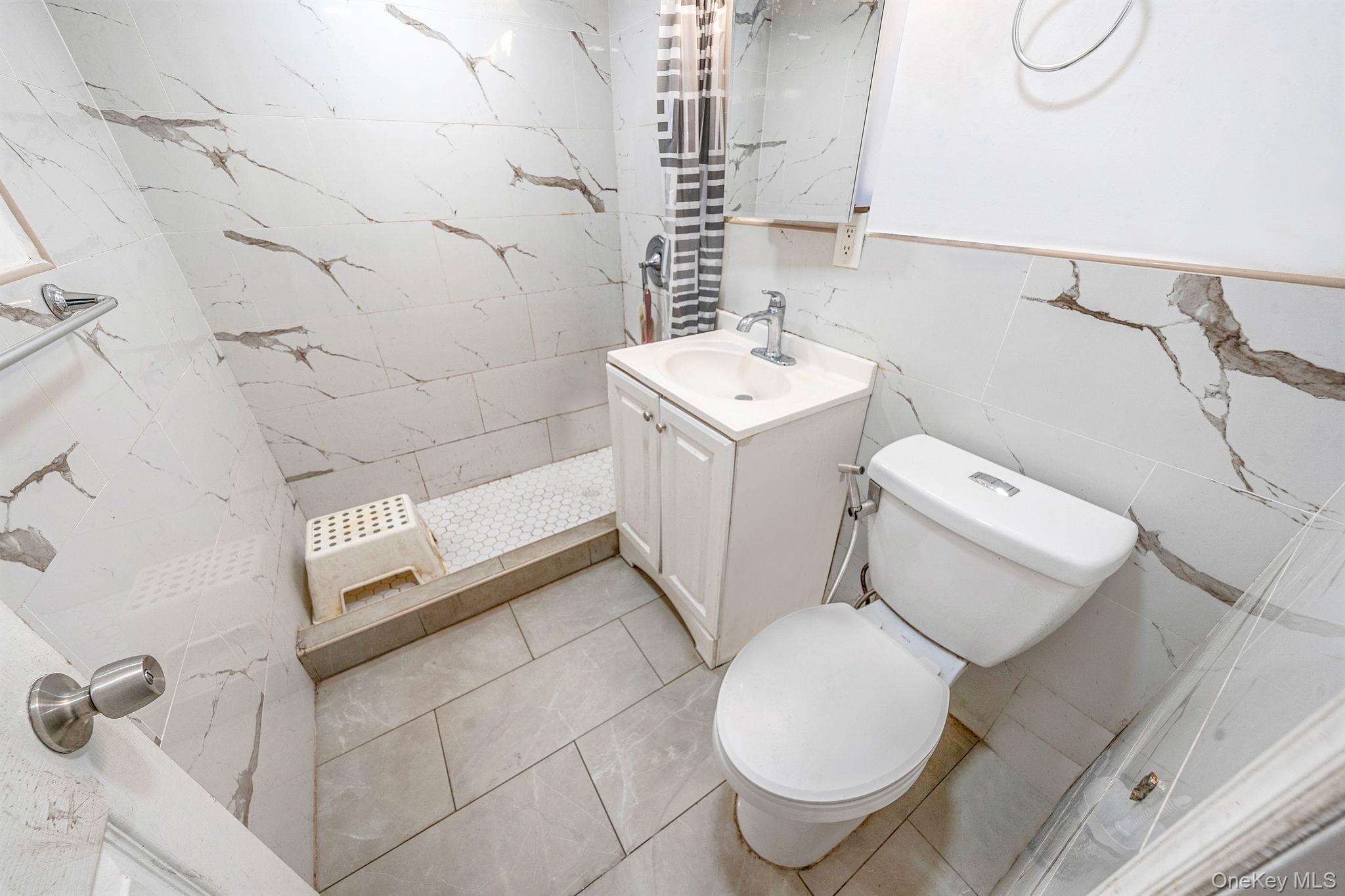 98 Miriam Street Valley Stream, NY 11581 - Photo 15 of 16 a bathroom with a sink toilet and shower